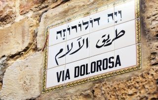 Street sign in Jerusalem saying 'Via Dolorosa' in Hebrew, Arabic and English Language