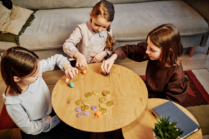 three girls playing Dreidel game for Hannukah